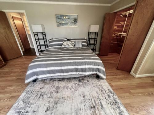 a bedroom with a large bed with a striped blanket at Spacious Lake Retreat for Families in Saint Cloud