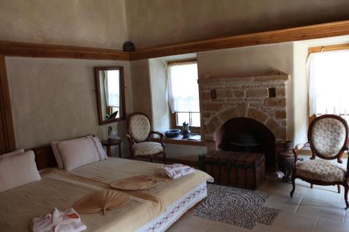 a bedroom with a bed and a fireplace at Mehmet Ali Ağa Konağı in Datca
