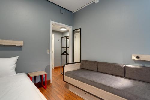 a room with a couch and a bed in it at Urban House Copenhagen by MEININGER in Copenhagen