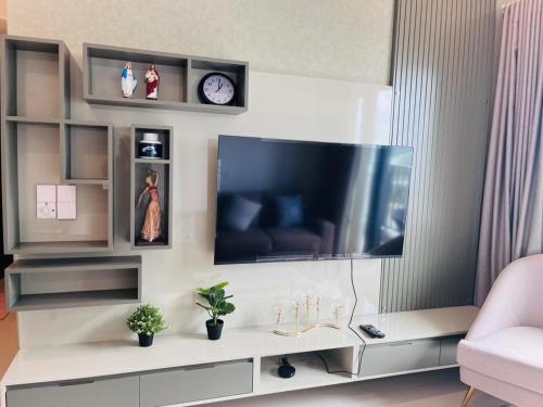 a living room with a flat screen tv on a wall at Colombo, Trizen Luxury Apartments, Sri Lanka in Colombo