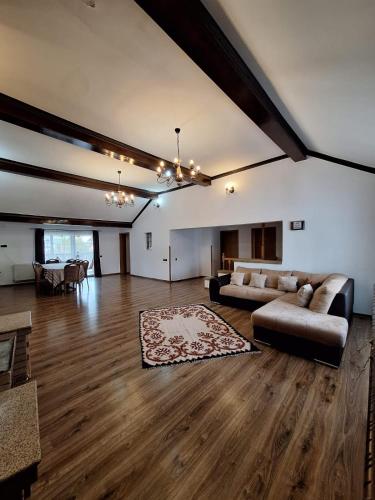 a large living room with a couch and a table at Casa Sofia in Vama