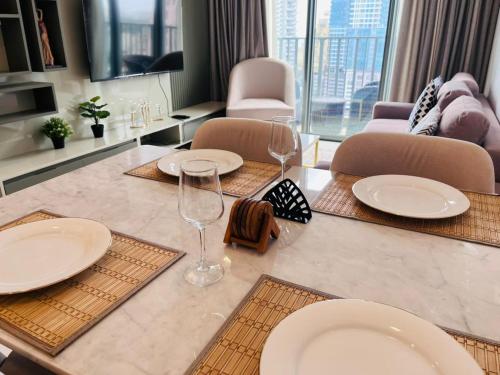a dining table with plates and wine glasses on it at Colombo, Trizen Luxury Apartments, Sri Lanka in Colombo