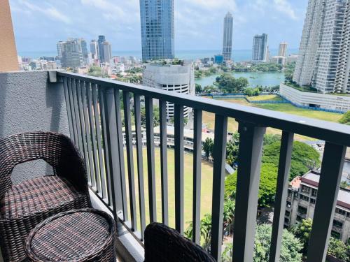 a chair sitting on a balcony with a view of a city at Colombo, Trizen Luxury Apartments, Sri Lanka in Colombo
