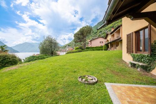 a yard of a house with a bowl in the grass at Antica Isola Giardino - Happy Rentals in Sala Comacina