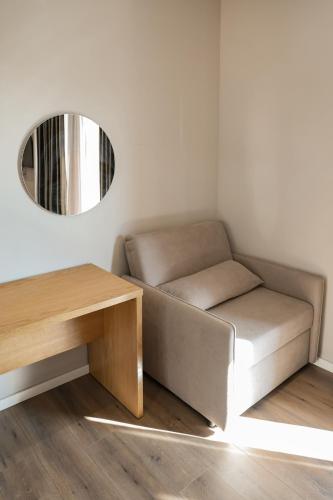 a couch and a table in a room with a mirror at Hotel Platinium Dhermi in Vlorë