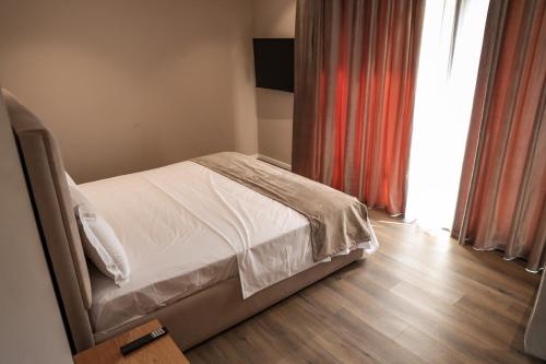 a bedroom with a bed and a window at Hotel Platinium Dhermi in Vlorë