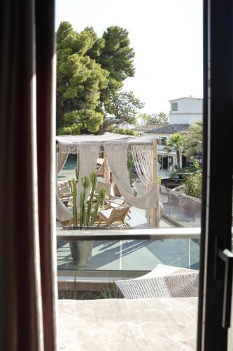 a view from a window of a patio with a hammock at Hotel Platinium Dhermi in Vlorë