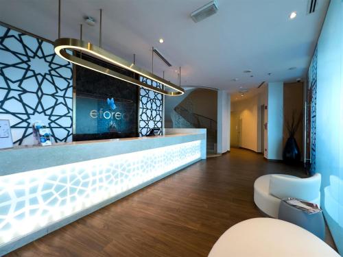 a lobby of a store with a reception counter at Hilton Doha in Doha