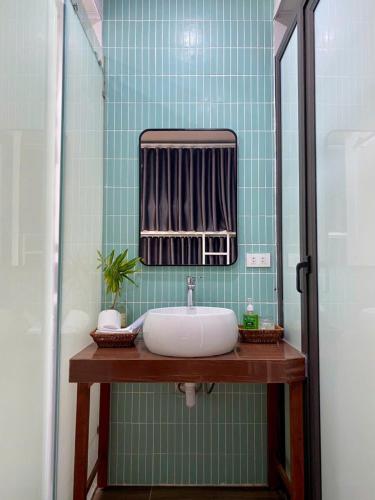 a bathroom with a sink and a mirror at Euphoria Cat Ba Homestay in Cat Ba