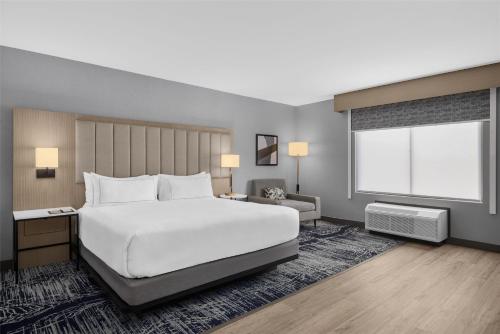 a bedroom with a large white bed and a window at DoubleTree by Hilton Las Vegas Airport in Las Vegas
