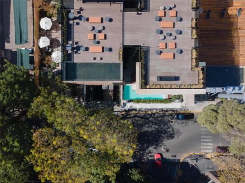 an overhead view of a building with a pool at Hualta Hotel Mendoza, Curio Collection by Hilton in Mendoza