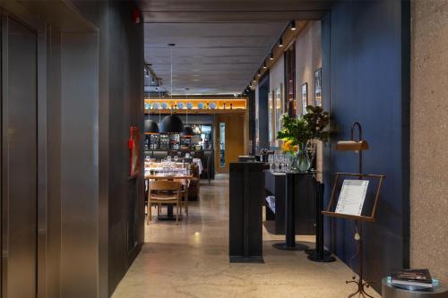 a view of a restaurant with blue walls and tables at Hualta Hotel Mendoza, Curio Collection by Hilton in Mendoza