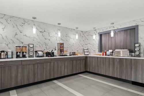 a restaurant with a counter and a counter at Baymont by Wyndham Batavia - Darien Lake in Batavia