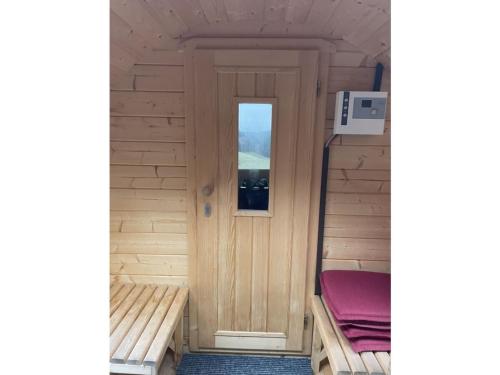 a wooden door in a small room with a window at Andi s Berghütte Comfortable holiday residence in Kötschendorf