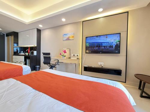 a hotel room with two beds and a flat screen tv at Highest Floor, Skyline Studio for 4Pax In Hoverland Genting Highlands in Genting Highlands