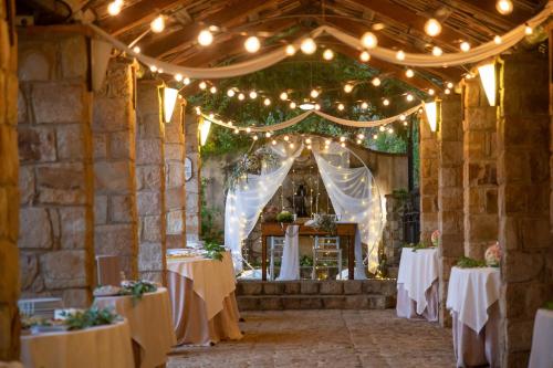 a set up for a wedding with lights and tables at Azienda Agrituristica Bergi in Castelbuono