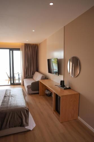 a living room with a couch and a table at Hotel Platinium Dhermi in Vlorë