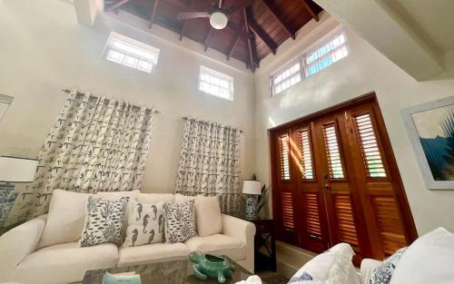 a living room with a white couch and windows at Jacks Place 3bd by ZenBreak in Saint Peter