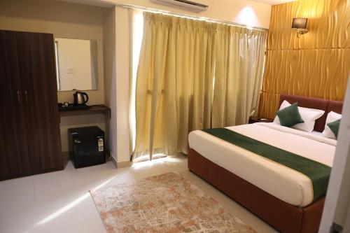 a bedroom with a bed and a window and a rug at Outstay Executive Apartments in Navi Mumbai