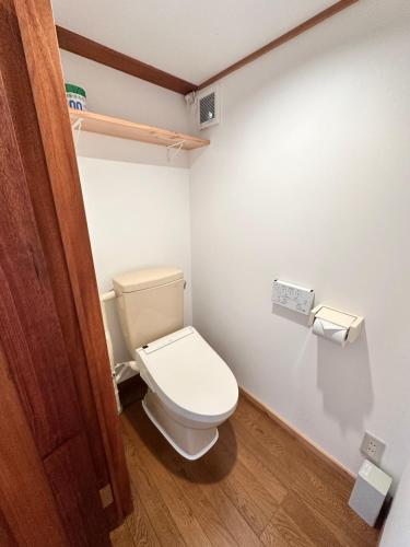 a bathroom with a toilet in a room at AOI SHIROYAMA 3-minute walk to the old streets of Hida Takayama in Takayama