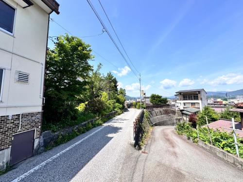 an empty street in a city with a building at AOI SHIROYAMA 3-minute walk to the old streets of Hida Takayama in Takayama