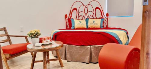 a bedroom with a bed and a table and a chair at Love Hotel Hóc Môn in Ho Chi Minh City