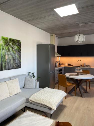 a living room with a couch and a table and a kitchen at Casa Angel Isora in Isora