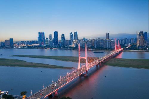 a bridge over a river with a city in the background at Yi Nian · Fangcun Hotel in Nanchang