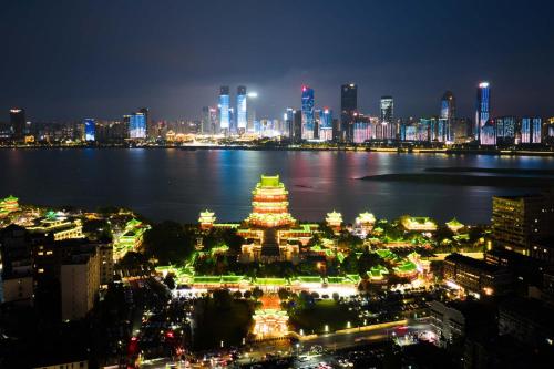 a view of a city at night with a pagoda at Yi Nian · Fangcun Hotel in Nanchang