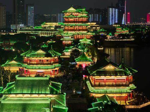 a group of buildings lit up at night at Yi Nian · Fangcun Hotel in Nanchang