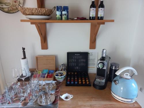 a counter with wine glasses and a tea kettle on it at Bed and Breakfast Hattem in Hattem