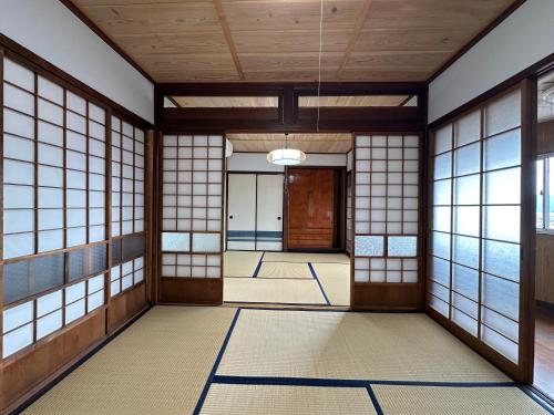 a japanese hallway with doors and windows at AOI SHIROYAMA 3-minute walk to the old streets of Hida Takayama in Takayama