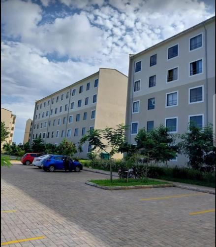 two large buildings with cars parked in a parking lot at 1255 Palm Ridge Estate in Vipingo