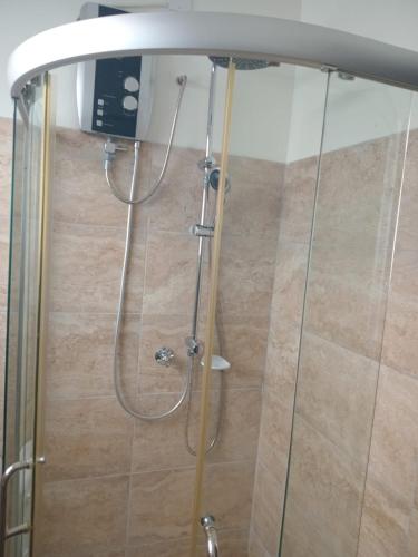 a shower in a bathroom with a glass door at 1255 Palm Ridge Estate in Vipingo