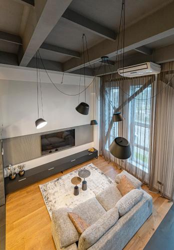 a living room with a couch and a table at Parko namai-loftas in Kaunas