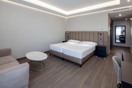 a bedroom with a bed and a couch and a table at Leflet Sanlucar in Sanlúcar la Mayor