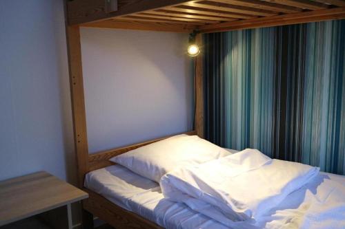 a bed in a room with a window at Hotell Marieberg in Kristinehamn