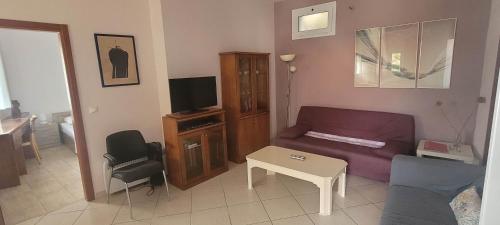 a living room with a couch and a tv at Agia Efimia Seaside in Agia Effimia in Ayia Evfimia