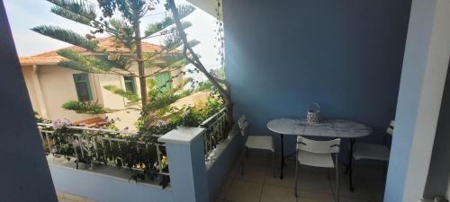 a balcony with a table and a small table and chairs at Agia Efimia Seaside in Agia Effimia in Ayia Evfimia