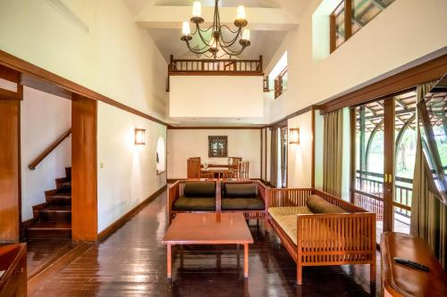 a living room with couches and a table at Novotel Bogor Golf Resort in Bogor