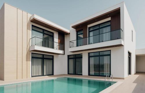 an exterior view of a house with a swimming pool at Angelo's farm in Jaipur