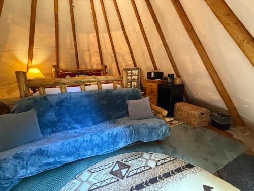 a living room with a blue couch in a attic at North Haven Campground in Bonners Ferry