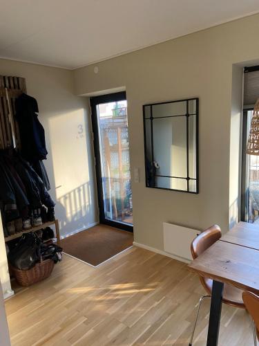 a room with a table and a mirror on the wall at Contemporary and Luxurious in Copenhagen