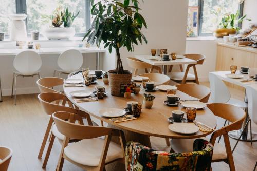 a dining room with tables and chairs and a plant at Residhome Nanterre La Défense in Nanterre