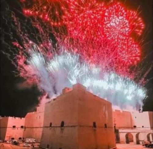 a firework display over a building in front at Tina's House in Barletta