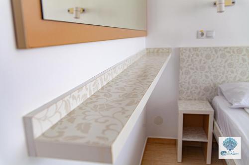 a staircase in a bedroom with a bed and a table at Hotel Carmen Azzuro in Venus