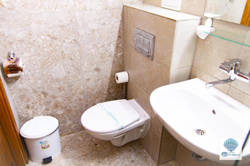 a bathroom with a toilet and a sink at Hotel Carmen Azzuro in Venus