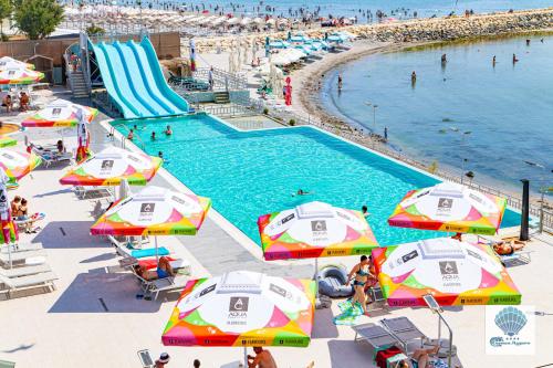 an overhead view of a pool with umbrellas and a beach at Hotel Carmen Azzuro in Venus