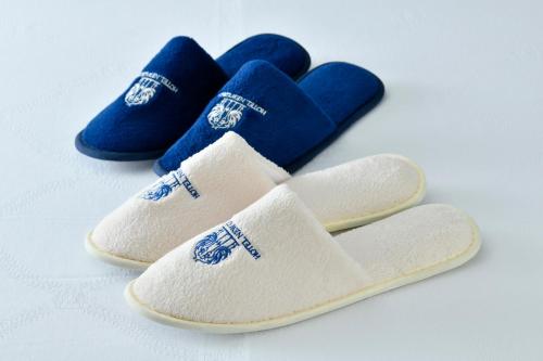 a pair of white and blue slippers with blue accents at Hotel New Grand in Yokohama