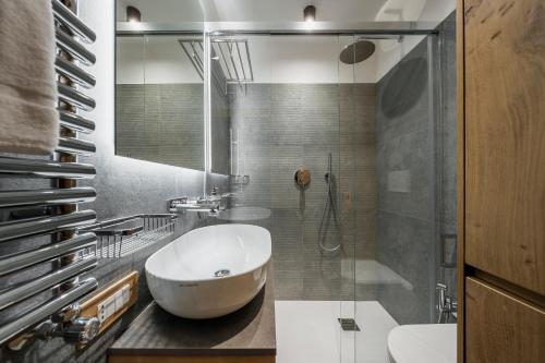 a bathroom with a tub and a sink and a shower at Chalet Belvedere - Dolomiti Skyline in Cortina dʼAmpezzo